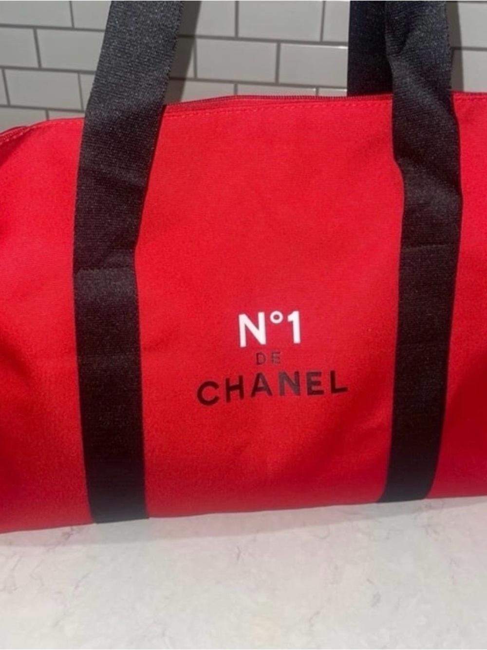 CHANEL Red Duffel Bag with Black Straps